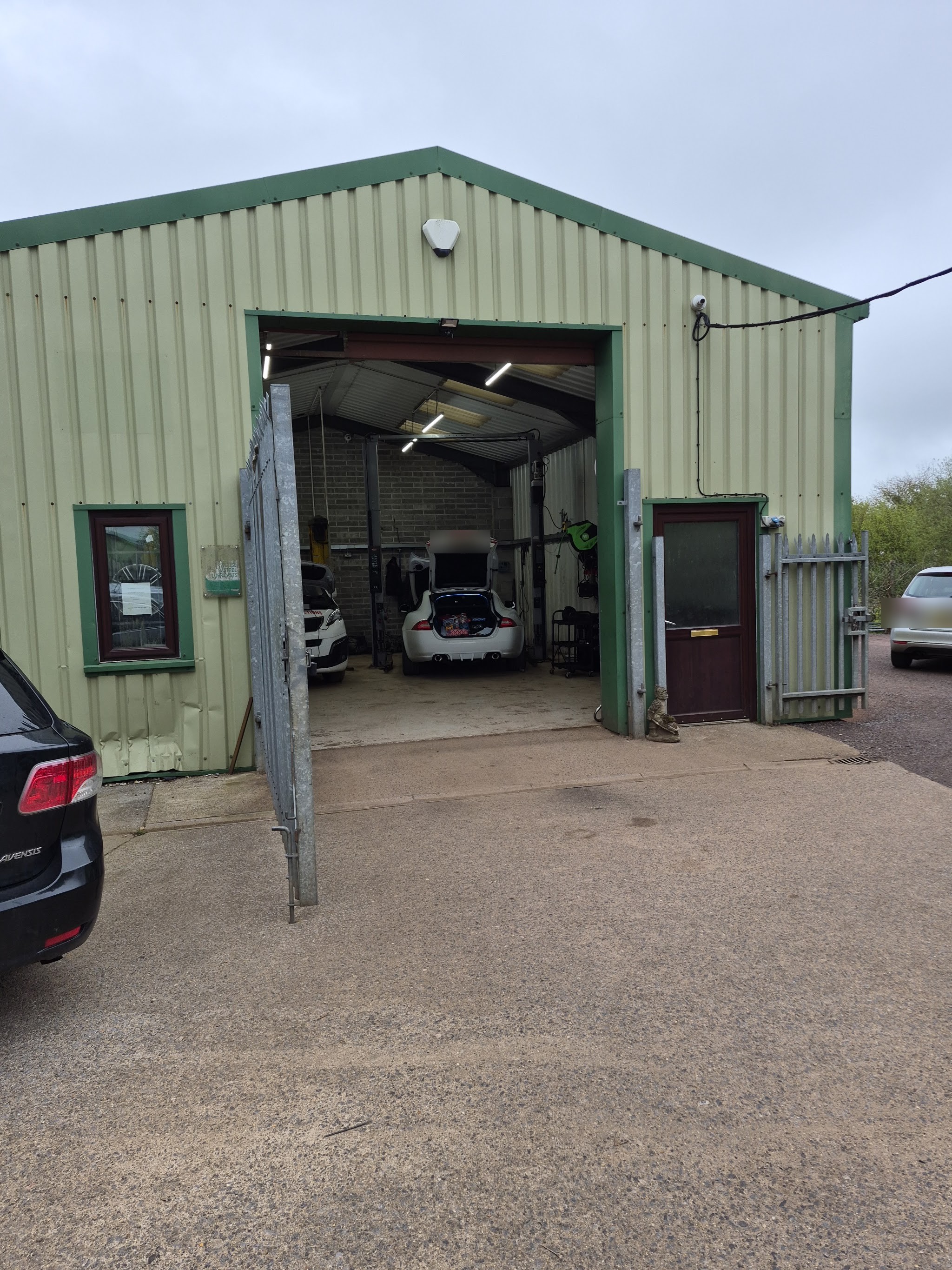 The green-trimmed workshop unit at Dunkeswell with its door open